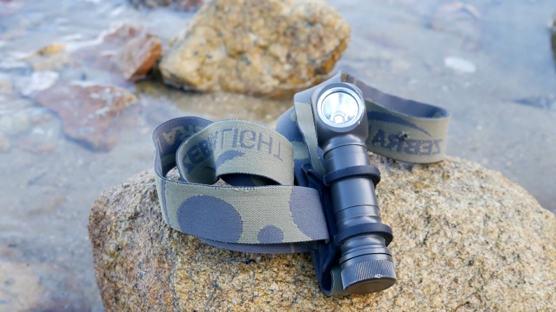 Zebralight H600w Mk IV headlamp resting on a rock by the water